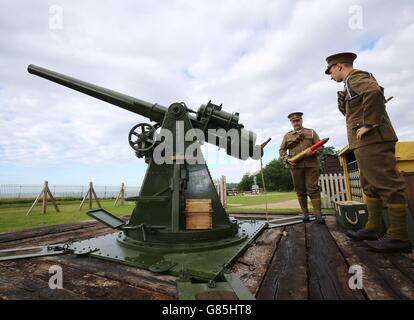 A First World War anti-aircraft gun is prepared to fire by members of the English Heritage Gun Crew Phil Harper (right) and James Blincow (left) at Dover Castle in Kent. Stock Photo