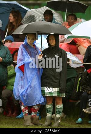 Highland dancers shelter from the rain at the Bridge of Allan Highland Games in Stirling, Scotland.
