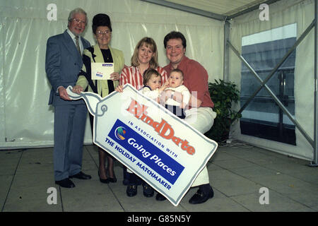 It's a double Blind Date success as the only two couples to meet and marry their partners from the hugely popular television show, hosted by Cilla Black (not pictured), come face-to-face with each other for the first time to celebrate the show's sponsorship by holiday matchmaker 'Going Places'. Pictured on the left are David and Lilian Fensom. On the right is Alex and Sue Tatham, with their children Charlie (six months) and Emily (two-and-a-half). The sponsorship credits of Going Places will be aired for the first time on Saturday, December 28. Stock Photo