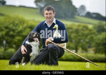 Sam the three-year-old Border Collie sheepdog and an Indian Runner duck with Meirion Owen, who trains Sam to herd ducks at their home in Rhos yr Hafod, Camarthen, Wales. Stock Photo