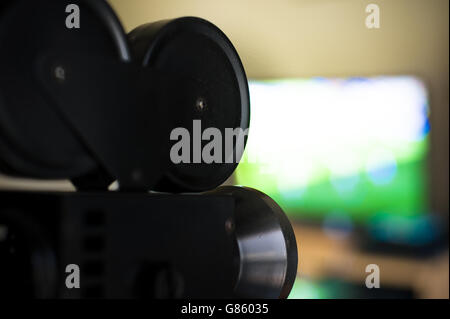 Vintage movie projector symbol and colorful screen in background, close up and selective focus Stock Photo