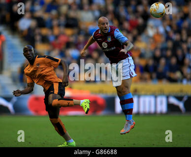 Aston Villa's Alan Hutton heads the ball away from Wolverhampton Wanderers' Benik Afobe (left) during the pre-season friendly at Molineux, Wolverhampton. Stock Photo