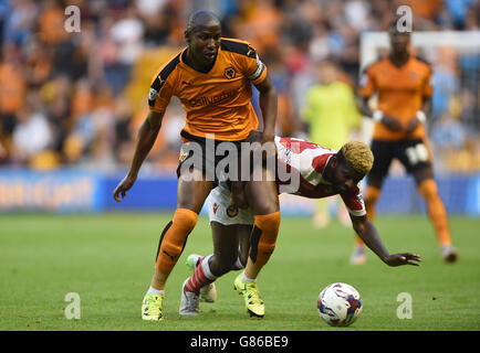 Wolverhampton Wanderers' Benik Afobe (left) and Newport County's Medy Elito (right) battle for the ball during the Capital One Cup, First Round match at Molineux, Wolverhampton. Stock Photo