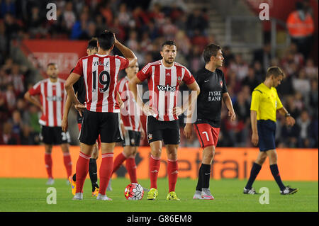 Southampton's Graziano Pelle and Jay Rodriguez (centre) stand dejected after FC Midtjylland's Tim Sparv (not in picture) scores his side's first goal of the game during the UEFA Europa League, Qualifying Play-offs, First Leg at St Mary's Stadium, Southampton. Stock Photo