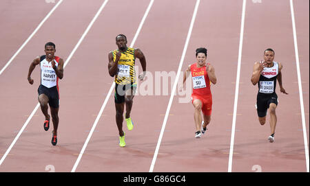 (From left to right) Turkey's Jak Ali Harvey, Jamaica's Usain Bolt, China's Bingtian Su and Canada's Andre De Grasse compete in the Men's 100 Metres Heat 1, during day two of the IAAF World Championships at the Beijing National Stadium, China. Stock Photo