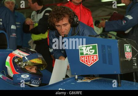 Motor Racing ... French Grand Prix. Alain Prost and replacement driver Jarno Trulli look at the practice times for the French Grand Prix Stock Photo