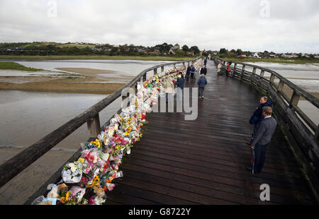 People stop to read floral tributes which have been placed on the Old Tollbridge near the A27 at Shoreham in West Sussex close to the scene of the Shoreham air disaster. Stock Photo