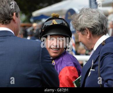 Jockey Frankie Dettori talks to trainer William Haggas (left) and the Queen's racing manager John Warren (right) after winning the Tattersalls Acomb Stakes during day one of the Welcome to Yorkshire Ebor Festival at York Racecourse. Stock Photo