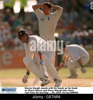 Darren Gough stands with his hands on his head as Shane Warne and Steve Waugh take three runs from his bowling. Stock Photo