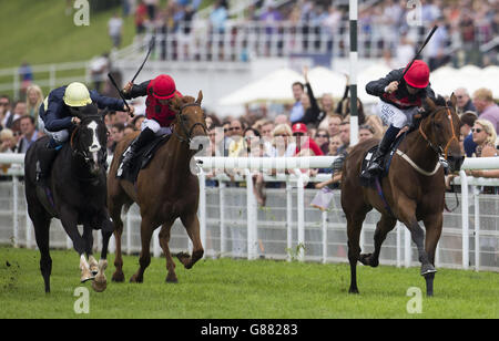 Royal Toast ridden by Cam Hardie (right) leads the field home to win the Harwoods Group Stakes Race run during day two of the Bank Holiday Weekend at Goodwood Racecourse. Stock Photo