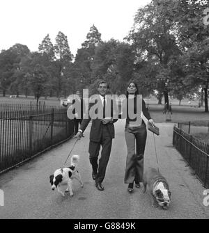 Two dogs that are set to appear in the new film 'The Spy With a Cold Nose' are taken for a walk in Kensington Gardens, London, by two of the stars of the film. Eric Sykes, who is walking Pickles, the dog that found the stolen Jules Rimet Trophy and has a part in the film, and Daliah Lavi has Disraeli, the Bulldog who plays the title role in the picture. Stock Photo