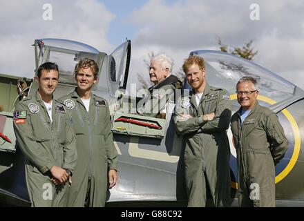 Prince Harry (second right) poses for a photograph with pilots and veteran Tom Neill after the 95-year-old ex-wing commander and Battle of Britain Hurricane and Spitfire pilot took part in the Battle of Britain Flypast to mark the 75th anniversary of victory in the Battle of Britain at Goodwood Aerodrome in West Sussex. Stock Photo