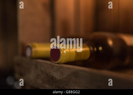 Two bottles of red wine on wooden shelf Stock Photo