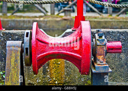 old and rusty gear pulley of a metal which was used to hoist the anchor of a ship Stock Photo