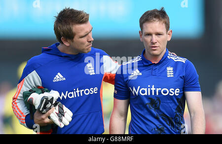 England's Eoin Morgan (right) leaves the pitch after being hit on the helmet by a delivery from Mitchell Starc, during the fifth match of the Royal London One Day International Series at Emirates Old Trafford, Manchester. Stock Photo