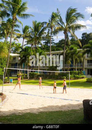 Children play volleyball at Daydream Island Resort; Whitsunday Islands, QLD, Australia Stock Photo
