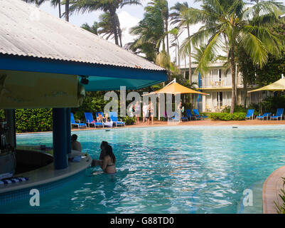 Relaxing by the pool at Daydream Island Resort; Whitsunday Islands, QLD, Australia. Stock Photo