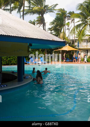 Relaxing by the pool at Daydream Island Resort; Whitsunday Islands, QLD, Australia. Stock Photo