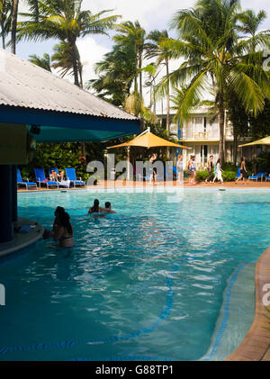 Relaxing by the pool at Daydream Island Resort; Whitsunday Islands, QLD, Australia. Stock Photo