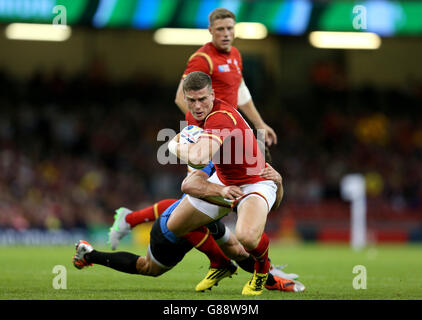 Wales' Scott Williams is tackled by Uruguay's Felipe Berchesi during the Rugby World Cup match at the Millennium Stadium, Cardiff. Stock Photo