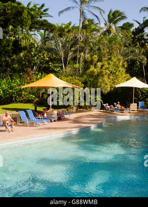 Relaxing by the pool at Daydream Island Resort; Whitsunday Islands, QLD, Australia. Stock Photo