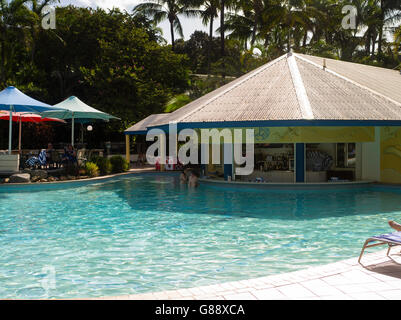 Relaxing by the pool at Daydream Island Resort; Whitsunday Islands, QLD, Australia. Stock Photo