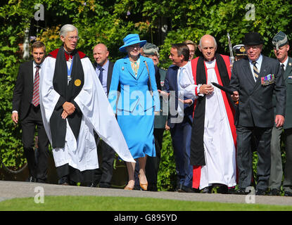 Queen Margrethe II of Denmark, (centre) Colonel-in-Chief of the Princess of Wales's Royal Regiment, the descendant regiment of The Buffs, walks with the Very Reverend Dr Robert Willis (left) Dean of Canterbury Cathedral and the Bishop of Dover Trevor Willmott (right), as she arrives at Canterbury Cathedral in Kent, to unveil a memorial statue, as the Regimental Association of the Queen's Own Buffs, the Royal Kent Regiment commissioned a 50 inch bronze statue to commemorate The Buffs in Canterbury. Stock Photo