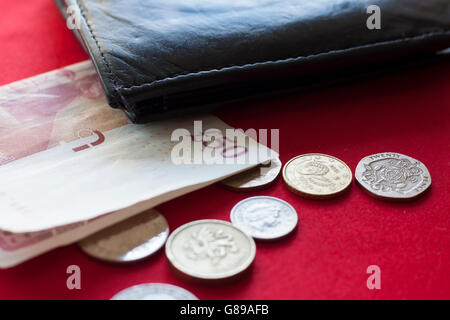 British pound in banknote and coins with black wallet Stock Photo