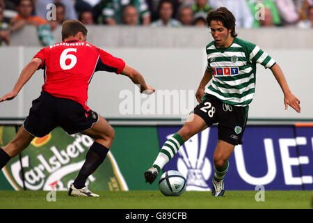 Sporting Lisbon's Joao Moutinho and CSKA Moscow's Aleksei Berezoutski battle for the ball Stock Photo