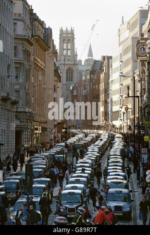 Taxis lined up on Fleet Street during a protest by the United Cabbies Group (UCG), which represents more than 1,400 London black cab drivers, over the regulation of private hire cars. Stock Photo