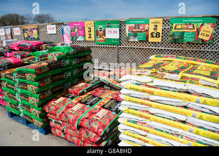 Stacks of bags of peat compost on sale at a garden centre, UK Stock Photo