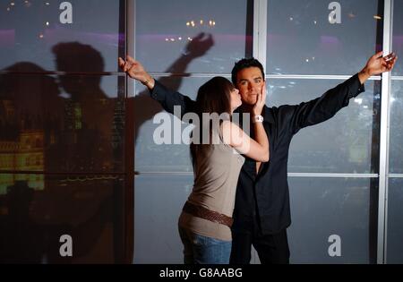 Model Emma Saville, 24 from London, with the new interactive Robbie Williams waxwork. Guests can activate the twinkle in his eyes by placing a kiss on his cheek. Stock Photo