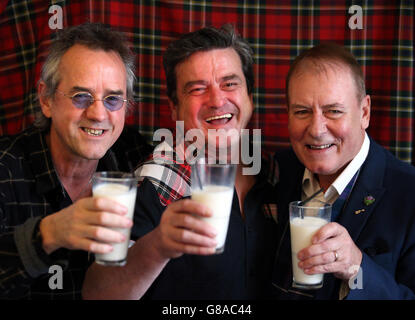 Bay City Rollers (left to right) Stuart Wood, Les McKeown and Alan Longmuir toast with milk as they make the announcement of their reunion at Central Hotel in Glasgow. Stock Photo