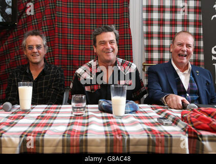 Bay City Rollers (left to right) Stuart Wood, Les McKeown and Alan Longmuir toast with milk as they make the announcement of their reunion at Central Hotel in Glasgow. Stock Photo