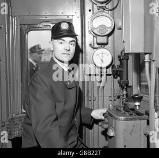 George Hawkins, 39, wears the new British Rail driver's uniform that goes into trial use on certain routes tomorrow. His new all-wool uniform is in medium blue grey and bears the distinguishing three gilt stars of the driver on the lapel. Stock Photo