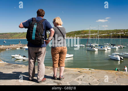 UK, Wales, Ceredigion, New Quay, visitors on Quay above boats moored in Harbour Stock Photo