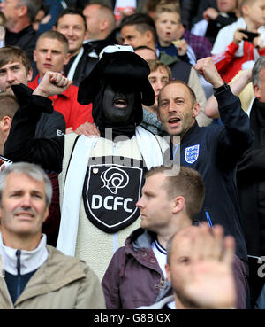 Soccer - Sky Bet Championship - Derby County v Wolverhampton Wanderers - iPro Stadium. Derby County fans, including a man dressed as a ram, show their support in the stands. Stock Photo