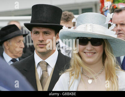 England and Real Madrid footballer Michael Owen (centre) watches his horse Evolution Ex finish fourth at Epsom. Stock Photo