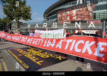 Arsenal and Manchester United fans protest outside the ground at the price of match day tickets before the Barclays Premier League match at the Emirates Stadium, London. Stock Photo