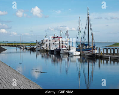 The small port marina in Burghsluis, Zeeland, the Netherlands, with tour cruise boat for tours on thea Oosterschelde. Stock Photo