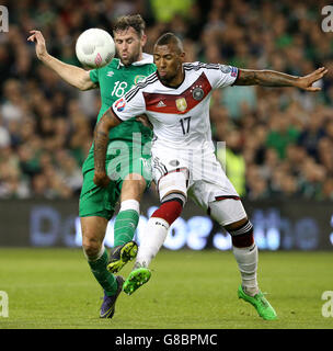 Germany's Jerome Boateng and Republic of Ireland's Daryl Murphy (left) battle for the ball during the UEFA European Championship Qualifying match at the Aviva Stadium, Dublin. Stock Photo