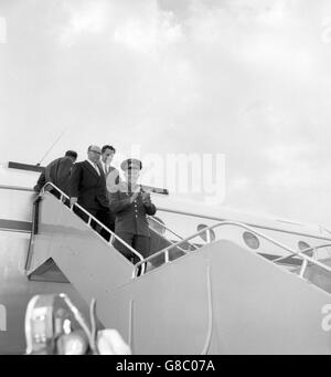 Smiling and clapping in response to the cheers and applause he received, Russian cosmonaut Major Yuri Gagarin, the first man in space, steps from a Soviet Tupolev Tu-104 jetliner on his arrival at London Airport. Stock Photo