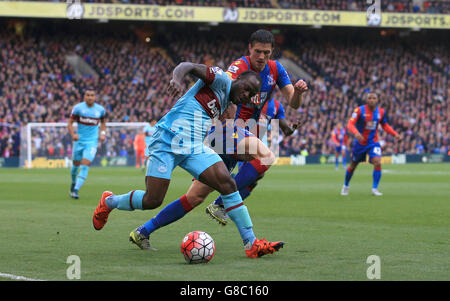 West Ham United's Victor Moses, (left) battles for possession of the ball with Crystal Palace's Martin Kelly, (right) during the Barclays Premier League match at Selhurst Park, London.