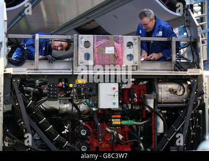 Employees work on a bus engine at Alexander Dennis Limited's plant in Falkirk, after the Scottish manufacturer signed a deal to build vehicles for the world's biggest producer of electric buses, which could be worth nearly &pound;2 billion. Stock Photo