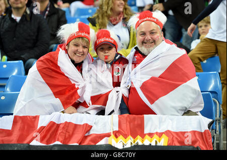 England fans wearing flags and colourful hats in the stands before the Rugby World Cup match at the City of Manchester Stadium. Stock Photo