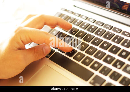 Male hands typing on keyboard Stock Photo