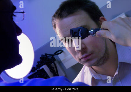 Eye examination using a Ophthalmoscope Stock Photo