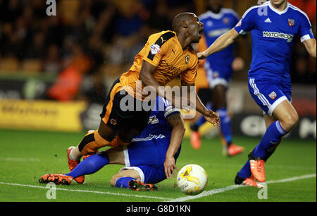 Wolverhampton Wanderers' Benik Afobe (left) is tackled by Brentford's Jake Bidwell during the Sky Bet Championship match at Molineux, Wolverhampton. Stock Photo