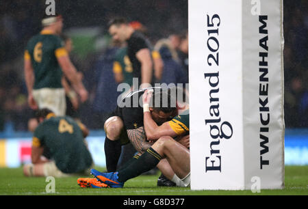South Africa's Jesse Kriel sits dejected as he is embraced by New Zealand's Sonny Bill Williams after the Rugby World Cup, Semi Final at Twickenham Stadium, London. Stock Photo