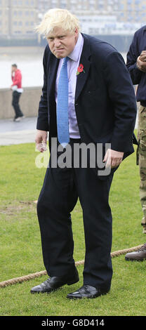 NOTE ALTERNATE CROP. Mayor of London Boris Johnson (second left) prepares to take part in a tug of war with personnel from the Royal Navy, the Army and the Royal Air Force at the launch of London Poppy Day, on Potters Field, next to City Hall in London. Stock Photo